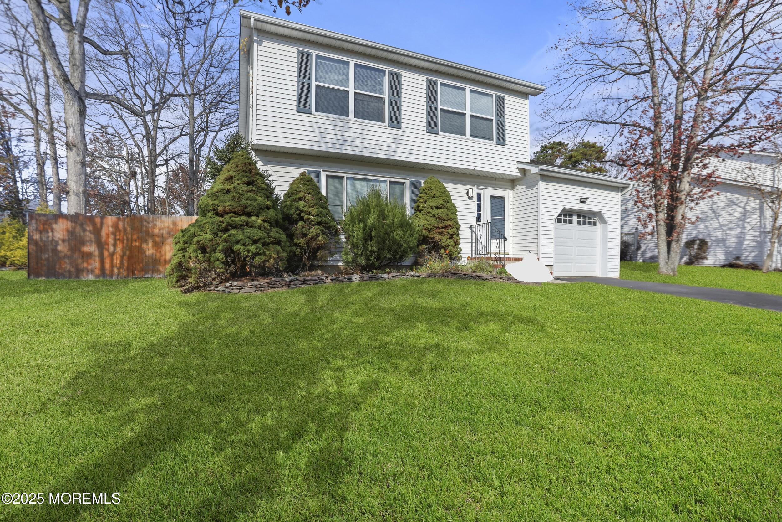 28 Bronia Street Howell, NJ 07731 - Photo 18 of 34 a view of a yard in front of a brick house with large windows