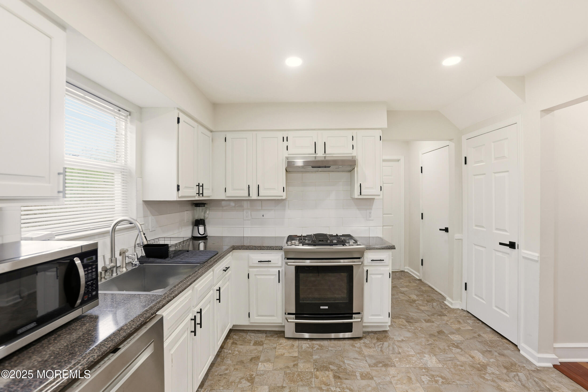 28 Bronia Street Howell, NJ 07731 - Photo 22 of 34 a kitchen with stainless steel appliances a stove a sink and a refrigerator