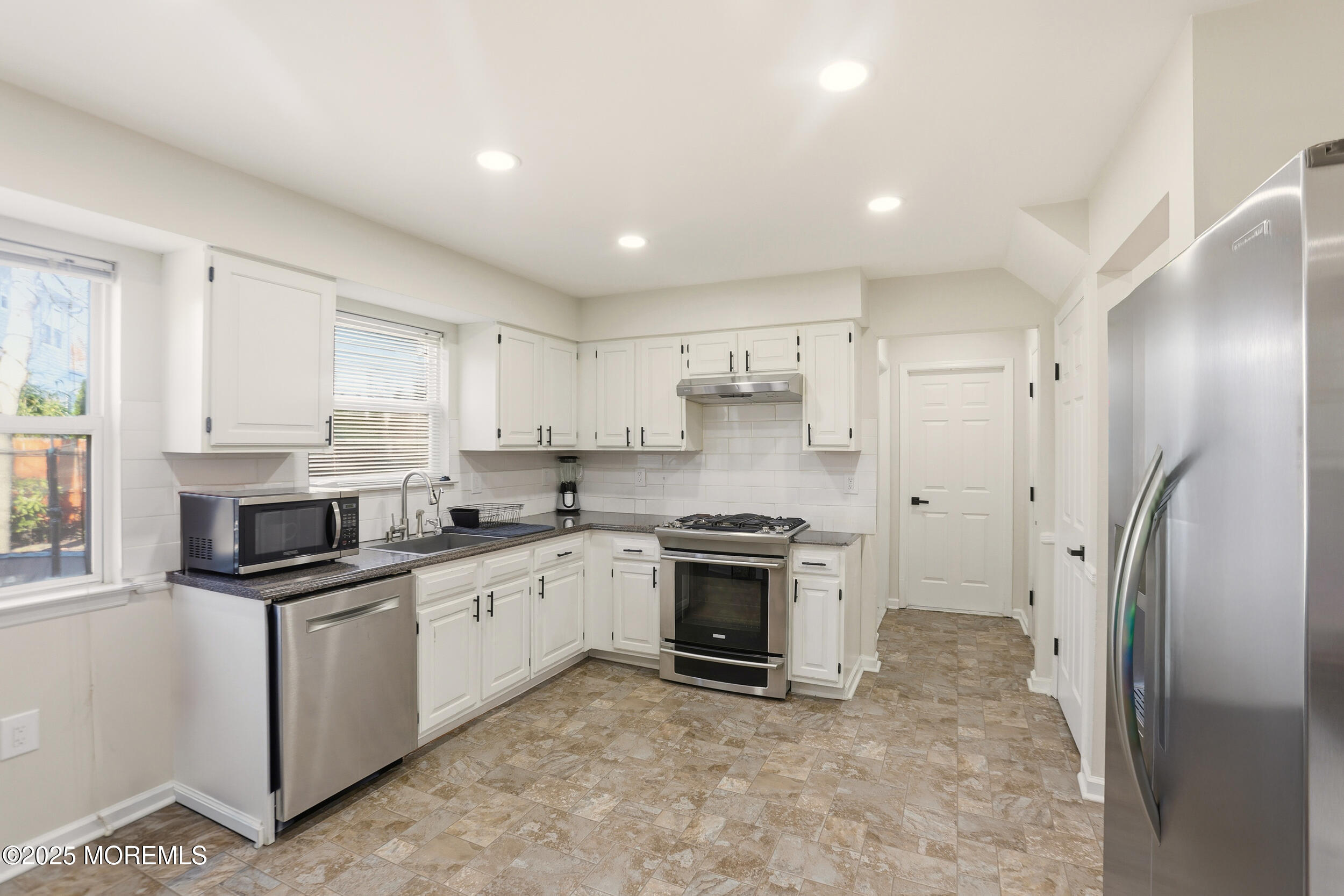 28 Bronia Street Howell, NJ 07731 - Photo 23 of 34 a kitchen with stainless steel appliances granite countertop a stove a sink and a refrigerator