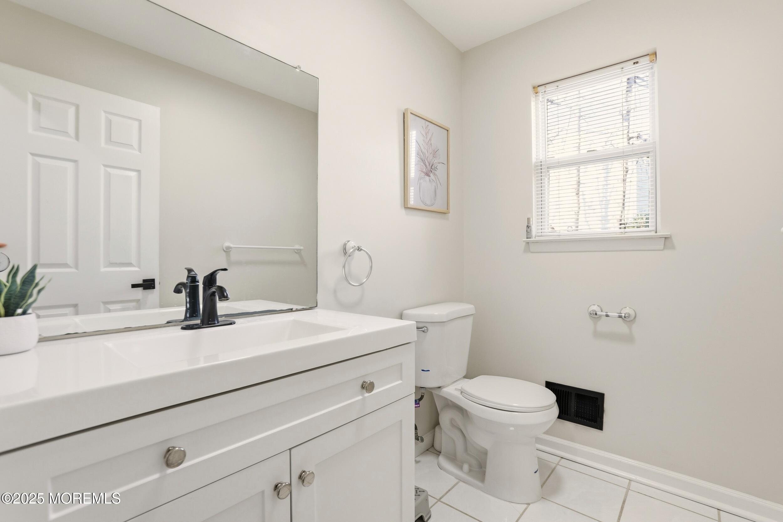 28 Bronia Street Howell, NJ 07731 - Photo 24 of 34 a bathroom with a sink a toilet and a mirror