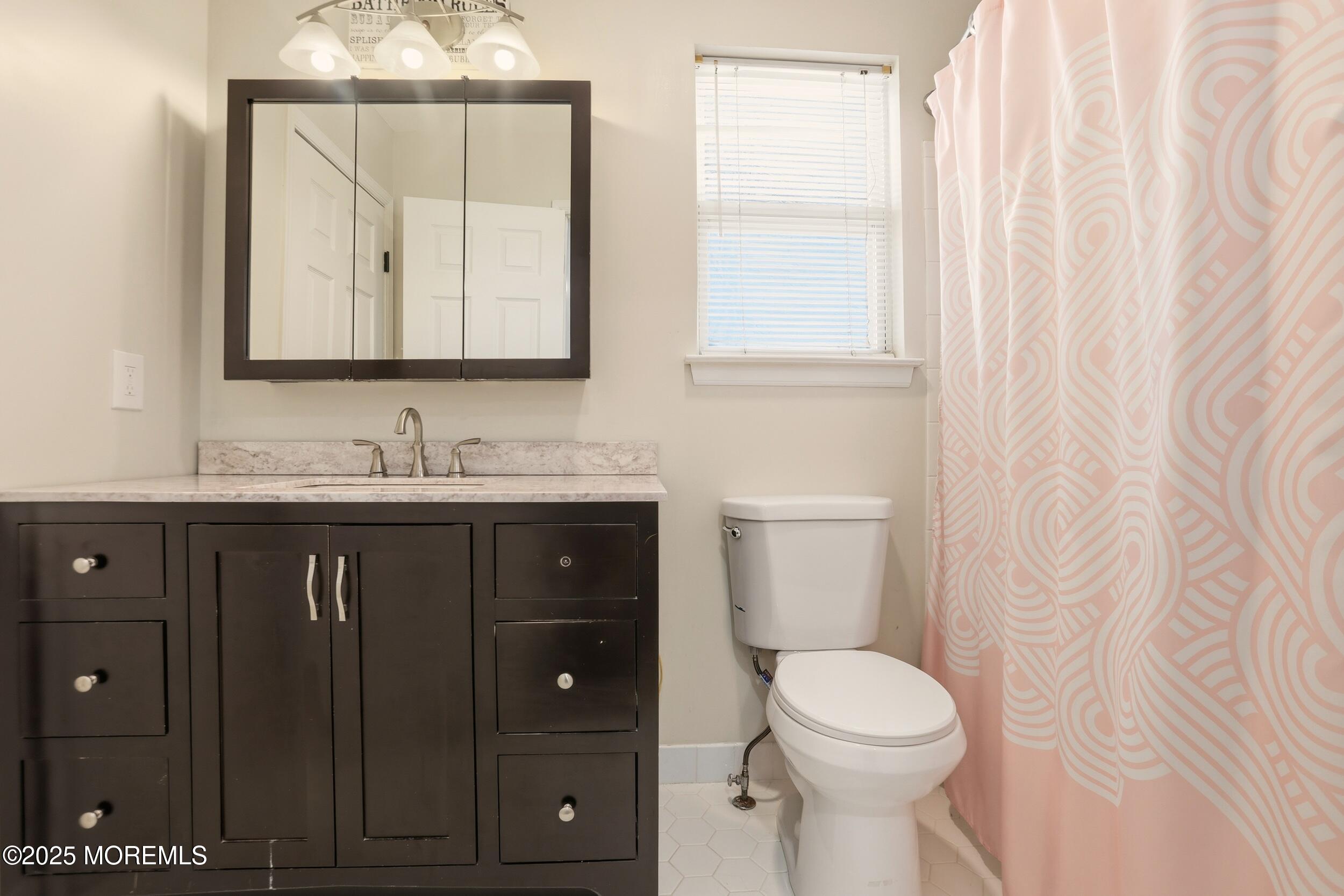 28 Bronia Street Howell, NJ 07731 - Photo 28 of 34 a bathroom with a sink vanity mirror and toilet