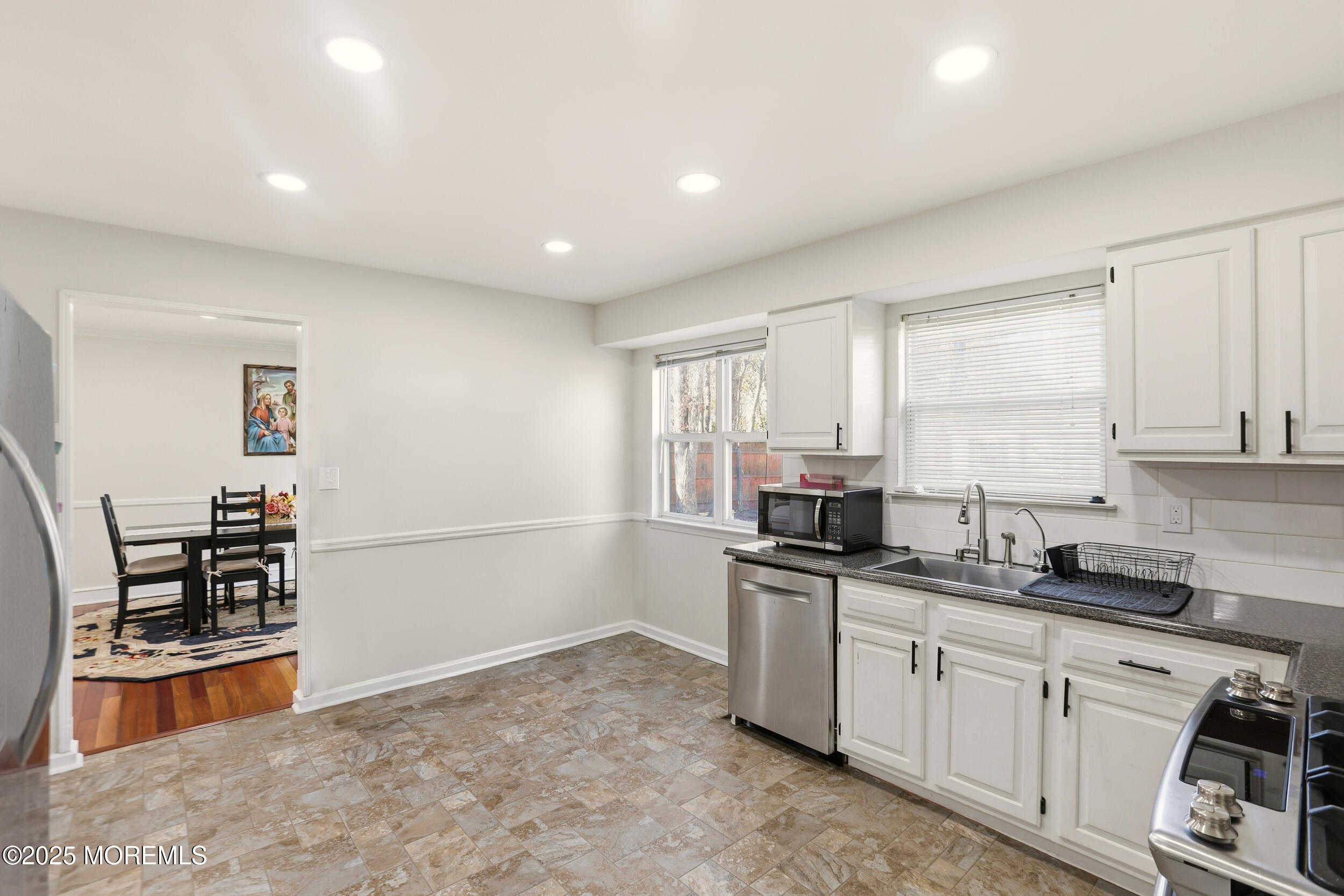 28 Bronia Street Howell, NJ 07731 - Photo 7 of 34 a kitchen with granite countertop a sink and cabinets