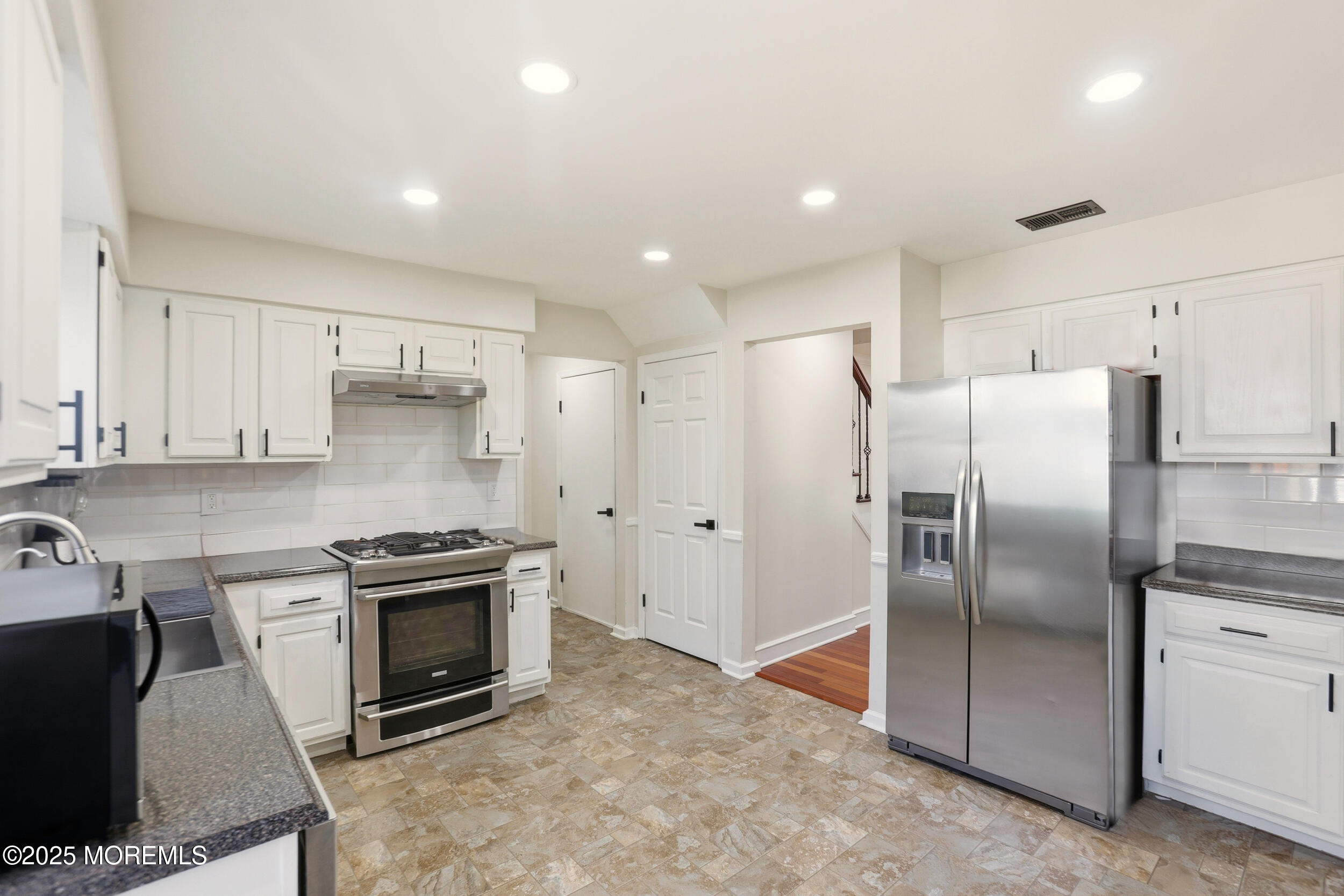 28 Bronia Street Howell, NJ 07731 - Photo 8 of 34 a kitchen with stainless steel appliances granite countertop a refrigerator a sink a stove and white cabinets