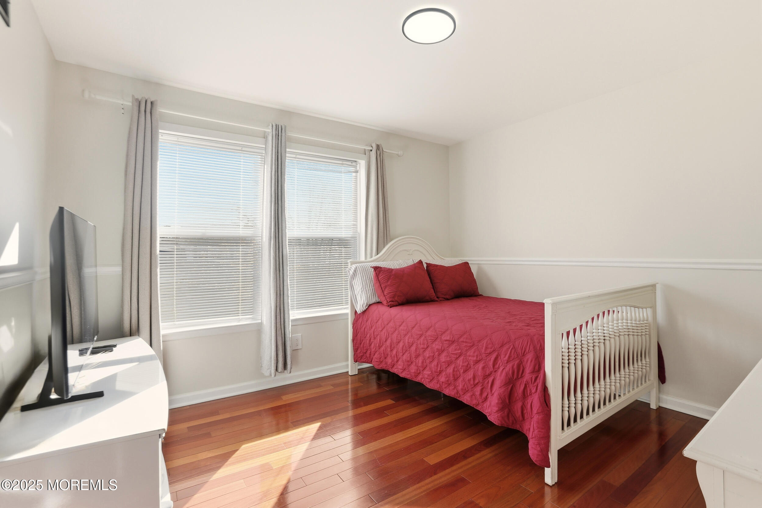 28 Bronia Street Howell, NJ 07731 - Photo 9 of 34 a bedroom with a bed and a flat tv screen next to a window