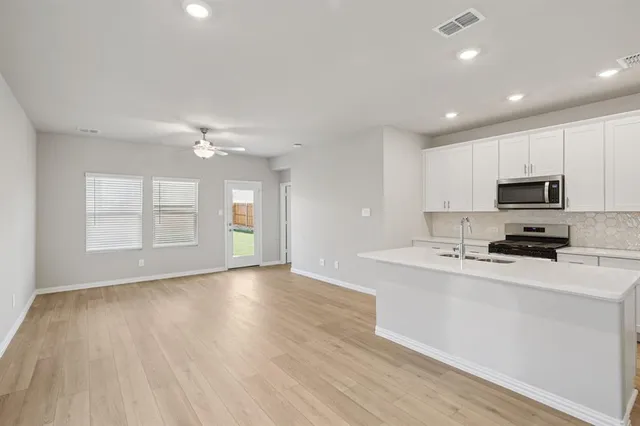 a view of a kitchen with microwave and cabinets