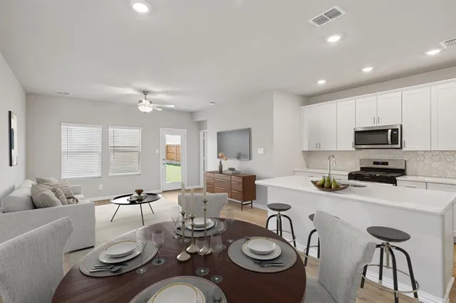a open dining room with furniture and wooden floor