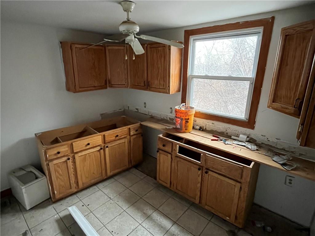 611 Singer Place Pittsburgh, PA 15221 - Photo 5 of 7 a kitchen with cabinets appliances and a window