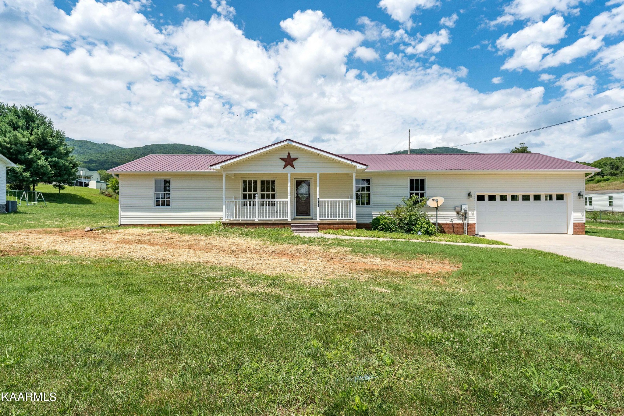 212 George Bowers Road Elizabethton, TN 37643 - Photo 1 of 49 a front view of a house with garden