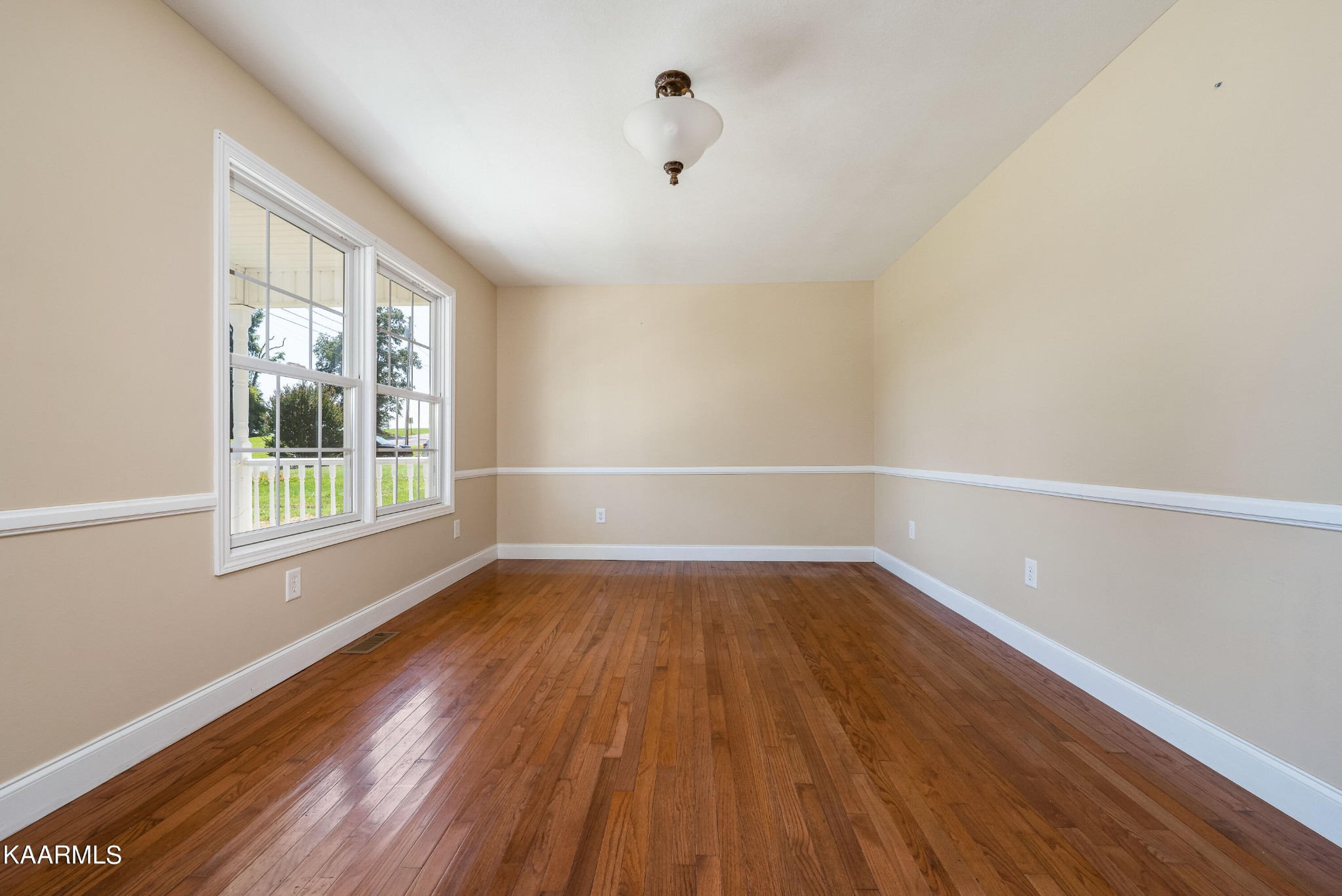 212 George Bowers Road Elizabethton, TN 37643 - Photo 25 of 49 a view of an empty room with wooden floor and a window