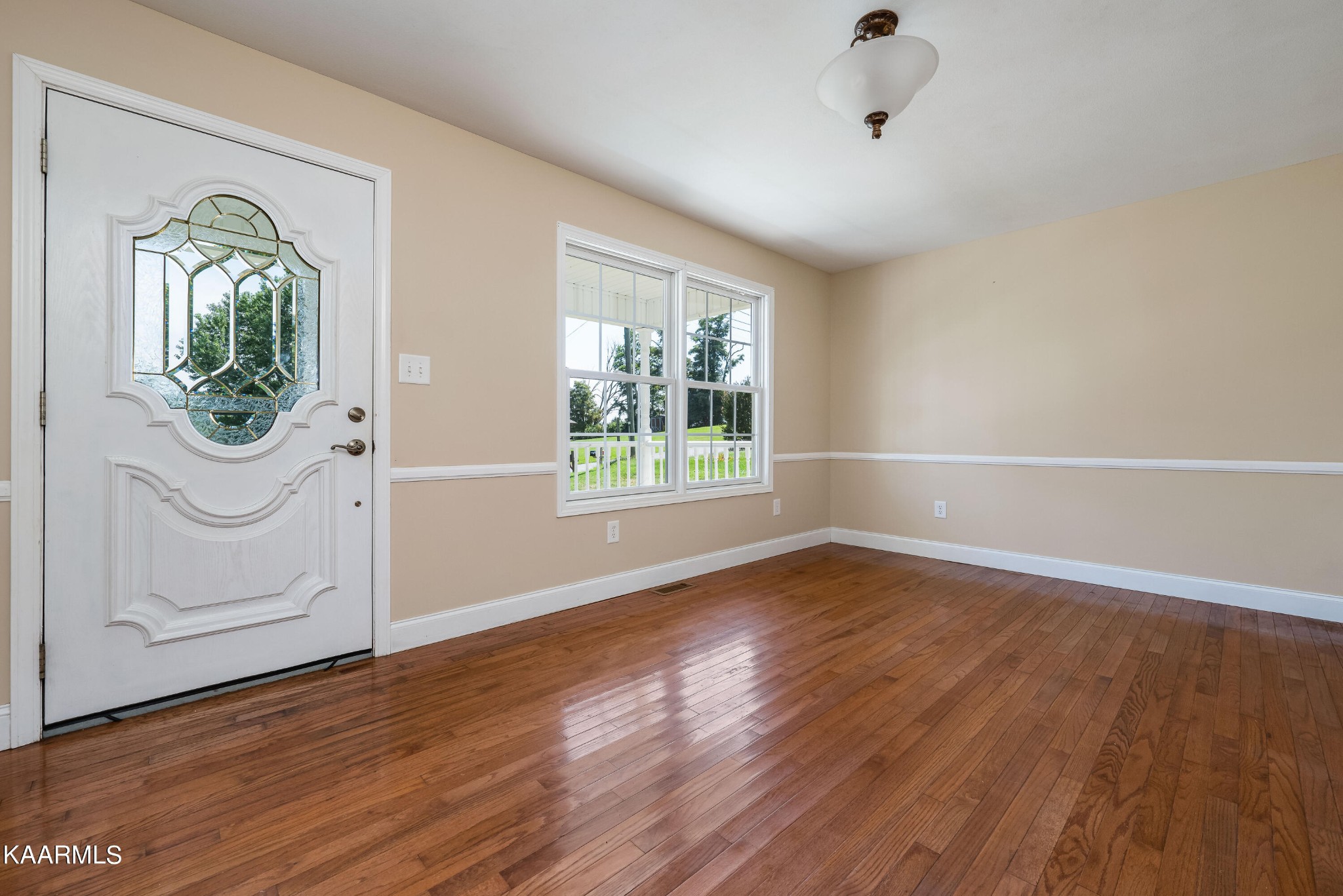 212 George Bowers Road Elizabethton, TN 37643 - Photo 26 of 49 a view of an empty room with wooden floor and a window