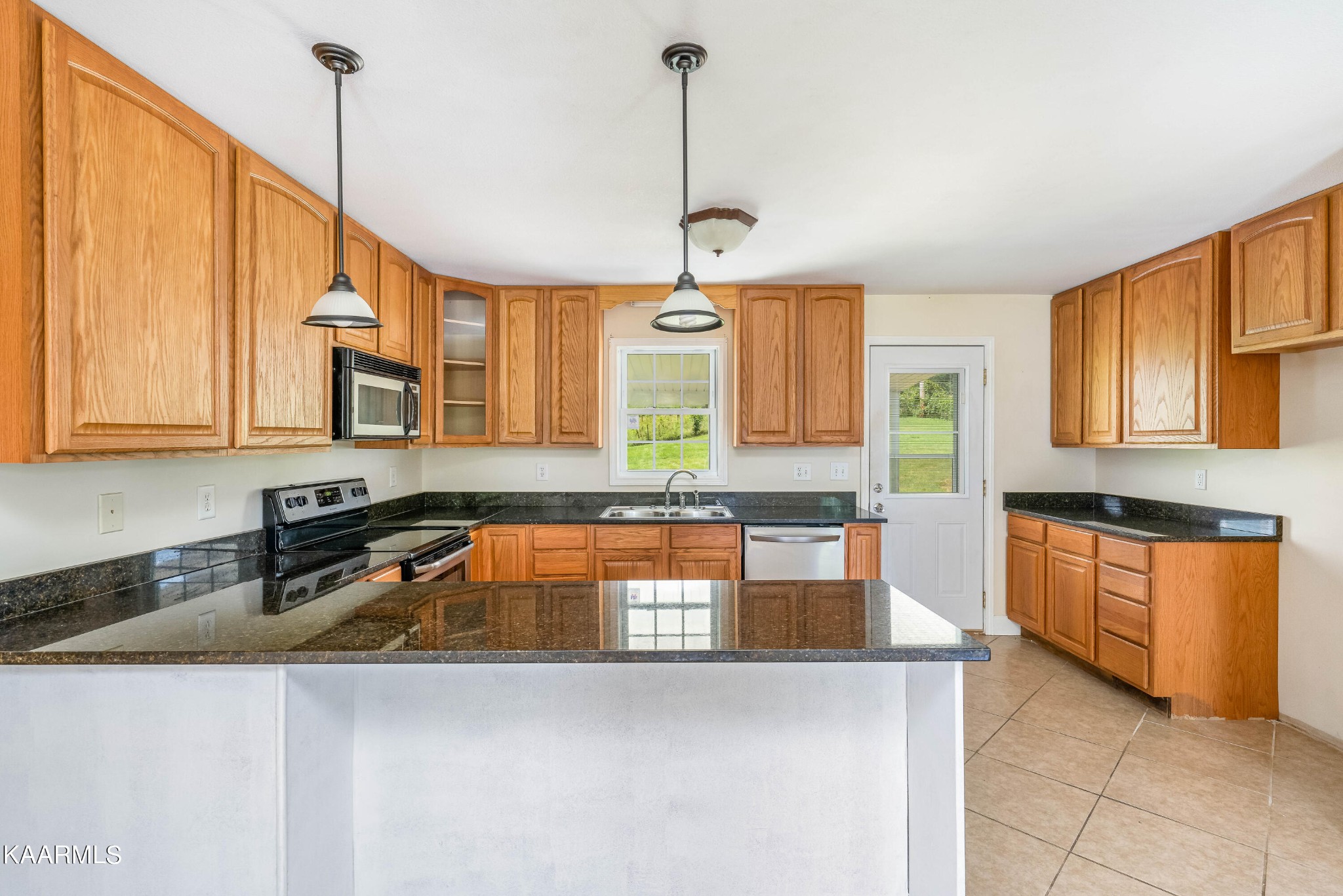 212 George Bowers Road Elizabethton, TN 37643 - Photo 32 of 49 a kitchen that has a lot of cabinets and a wooden floor