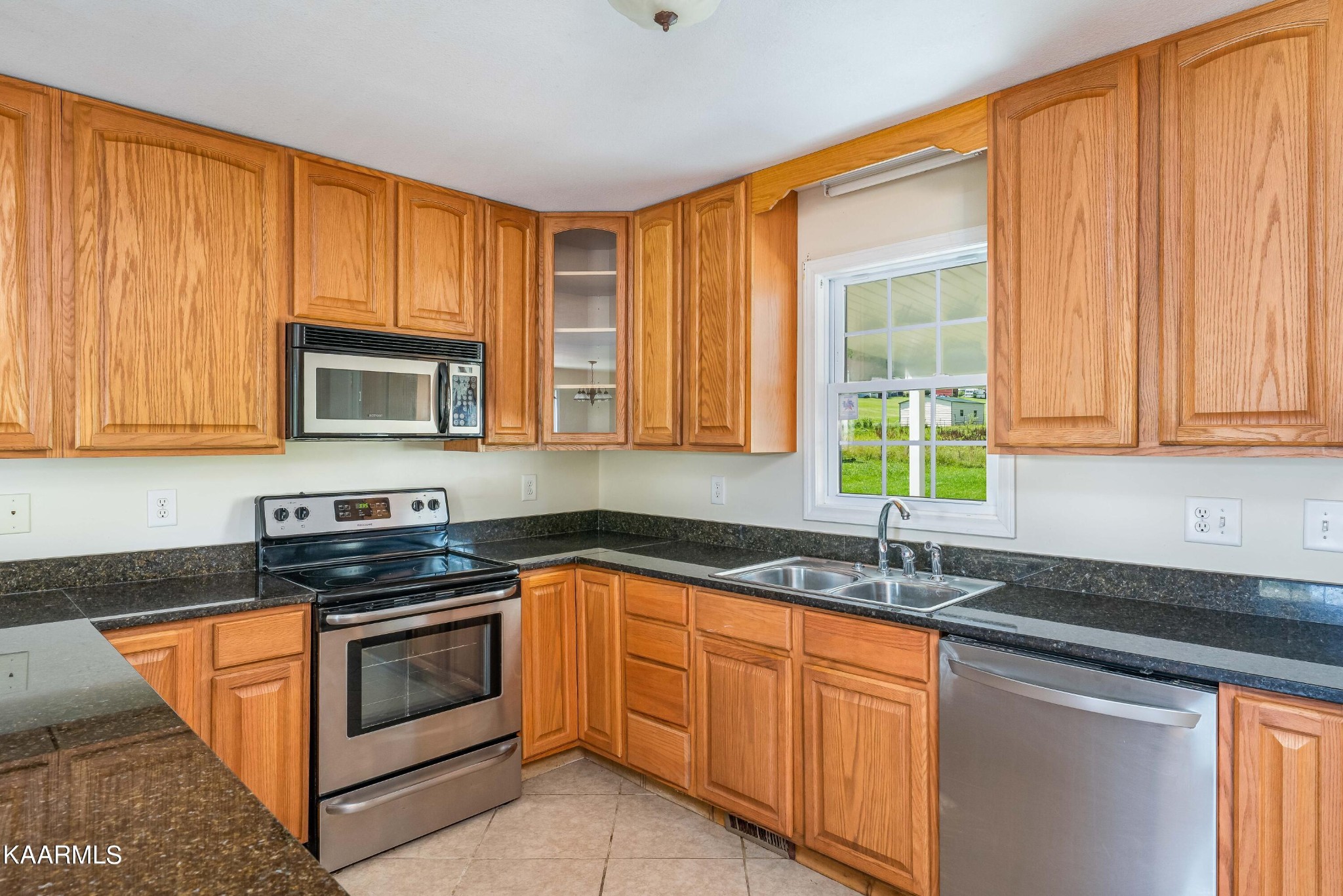 212 George Bowers Road Elizabethton, TN 37643 - Photo 33 of 49 a kitchen with stainless steel appliances granite countertop white cabinets sink and a granite counter top
