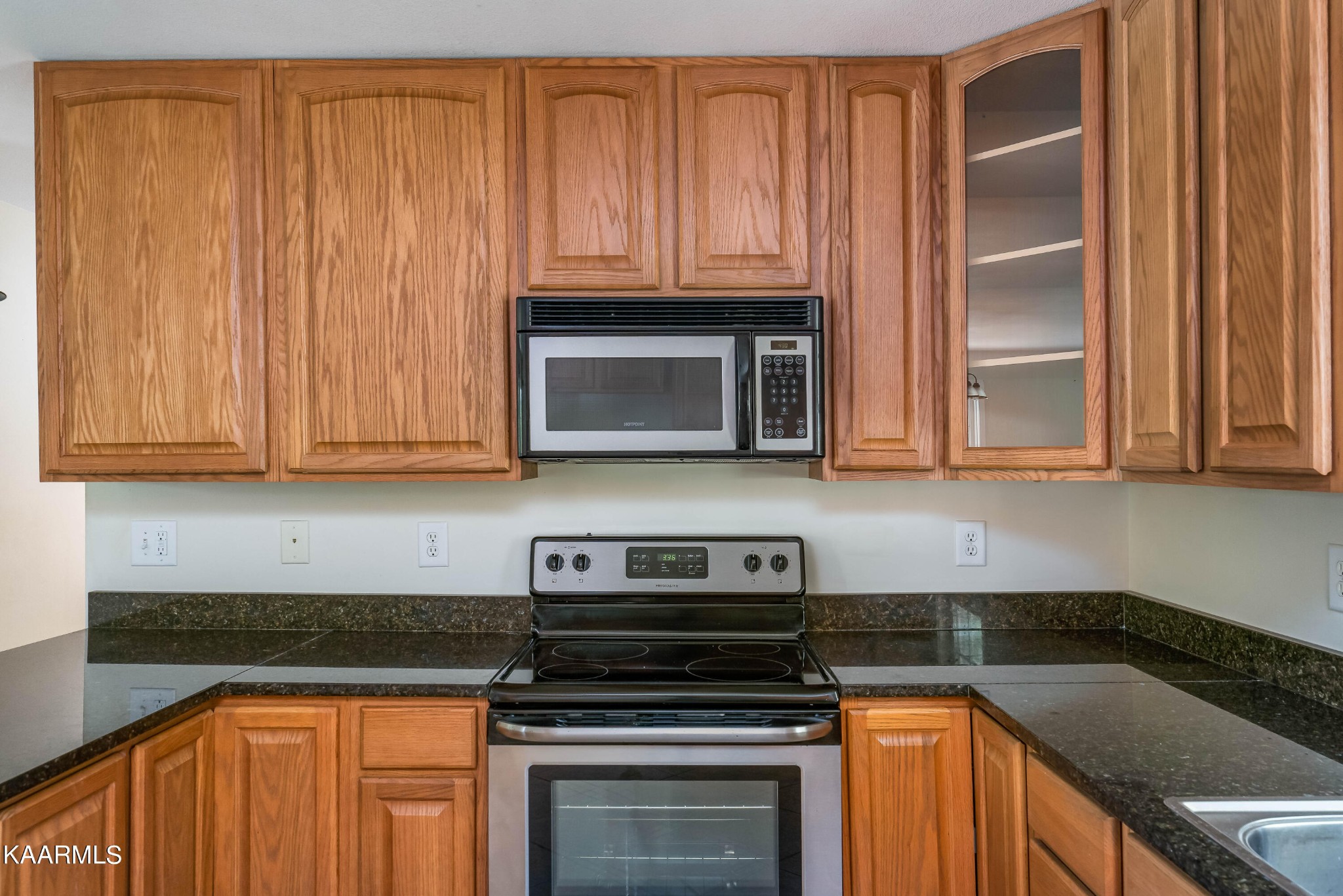 212 George Bowers Road Elizabethton, TN 37643 - Photo 34 of 49 a kitchen with granite countertop wood cabinets and stainless steel appliances