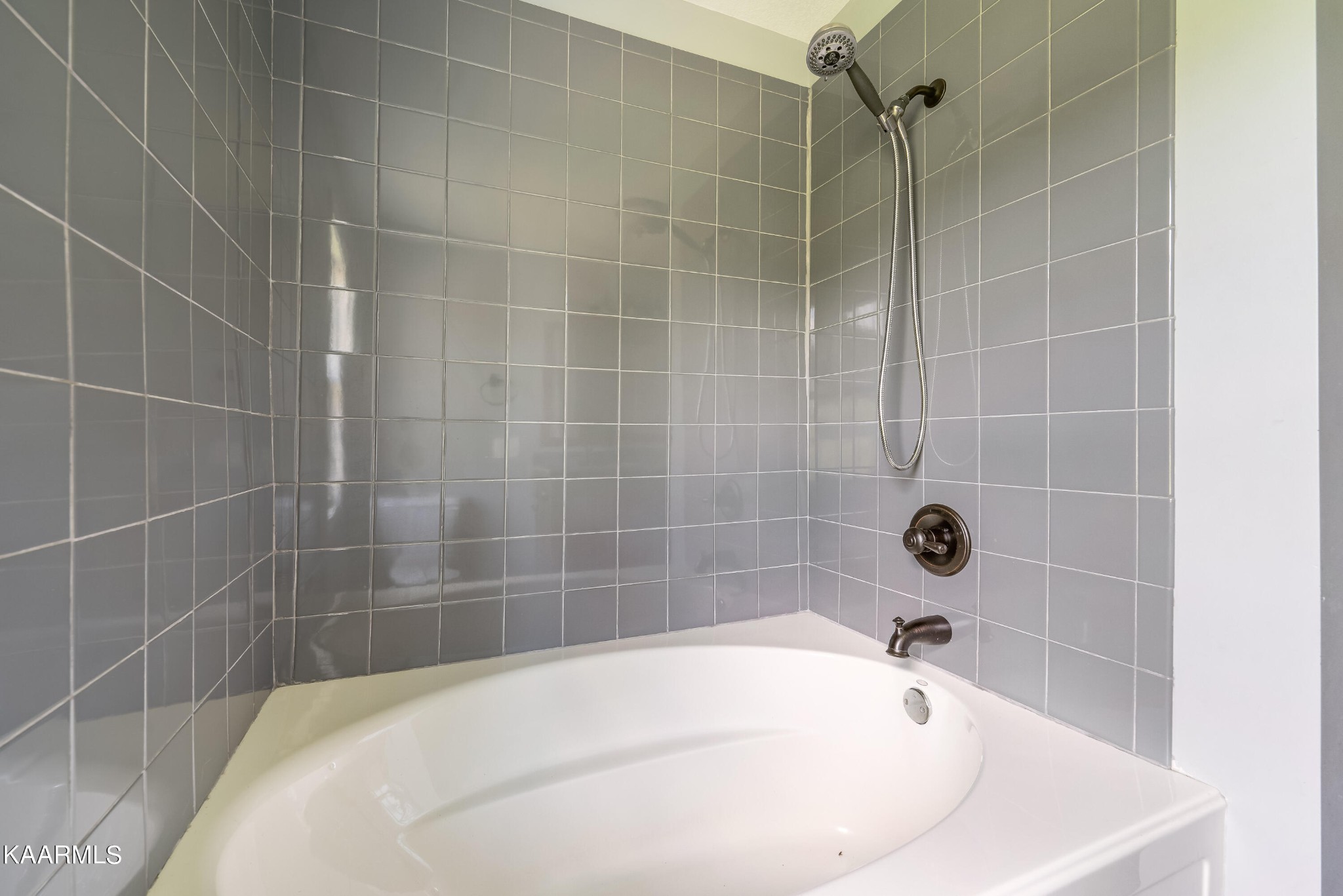 212 George Bowers Road Elizabethton, TN 37643 - Photo 43 of 49 a white bath tub sitting in a bathroom and a shower