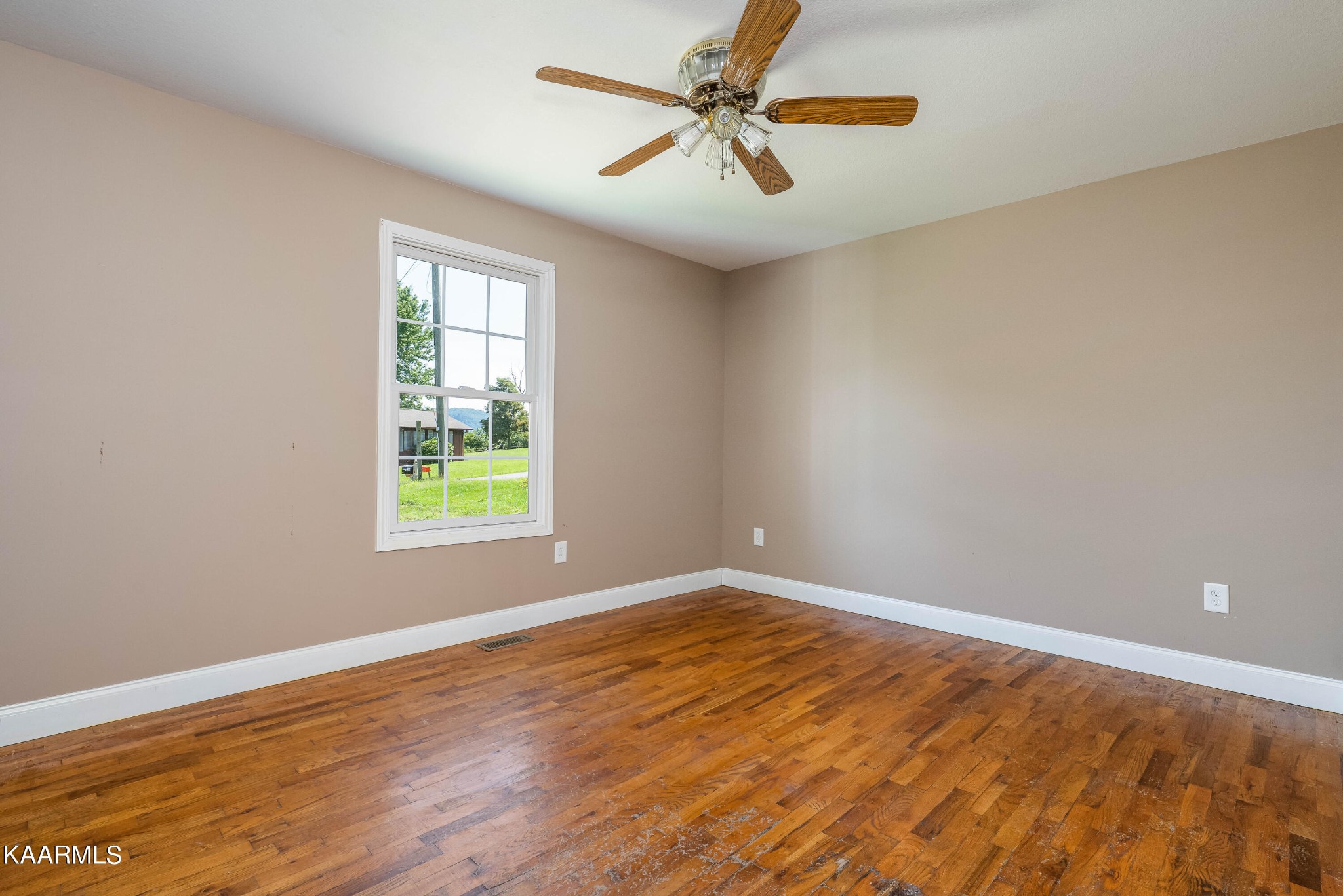 212 George Bowers Road Elizabethton, TN 37643 - Photo 44 of 49 wooden floor in an empty room with a window