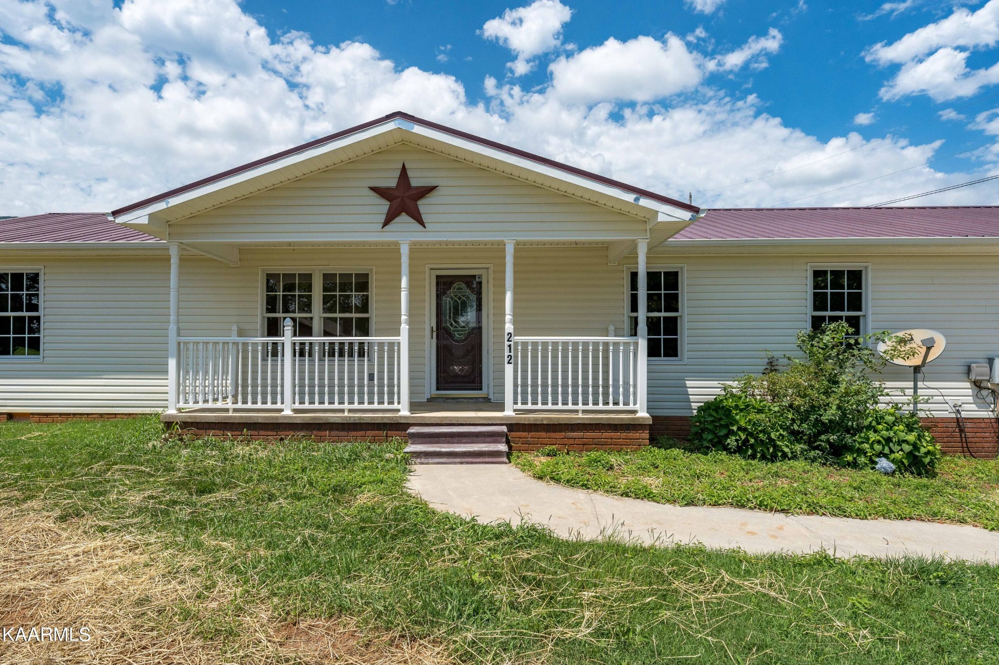 212 George Bowers Road Elizabethton, TN 37643 - Photo 5 of 49 a front view of a house with garden