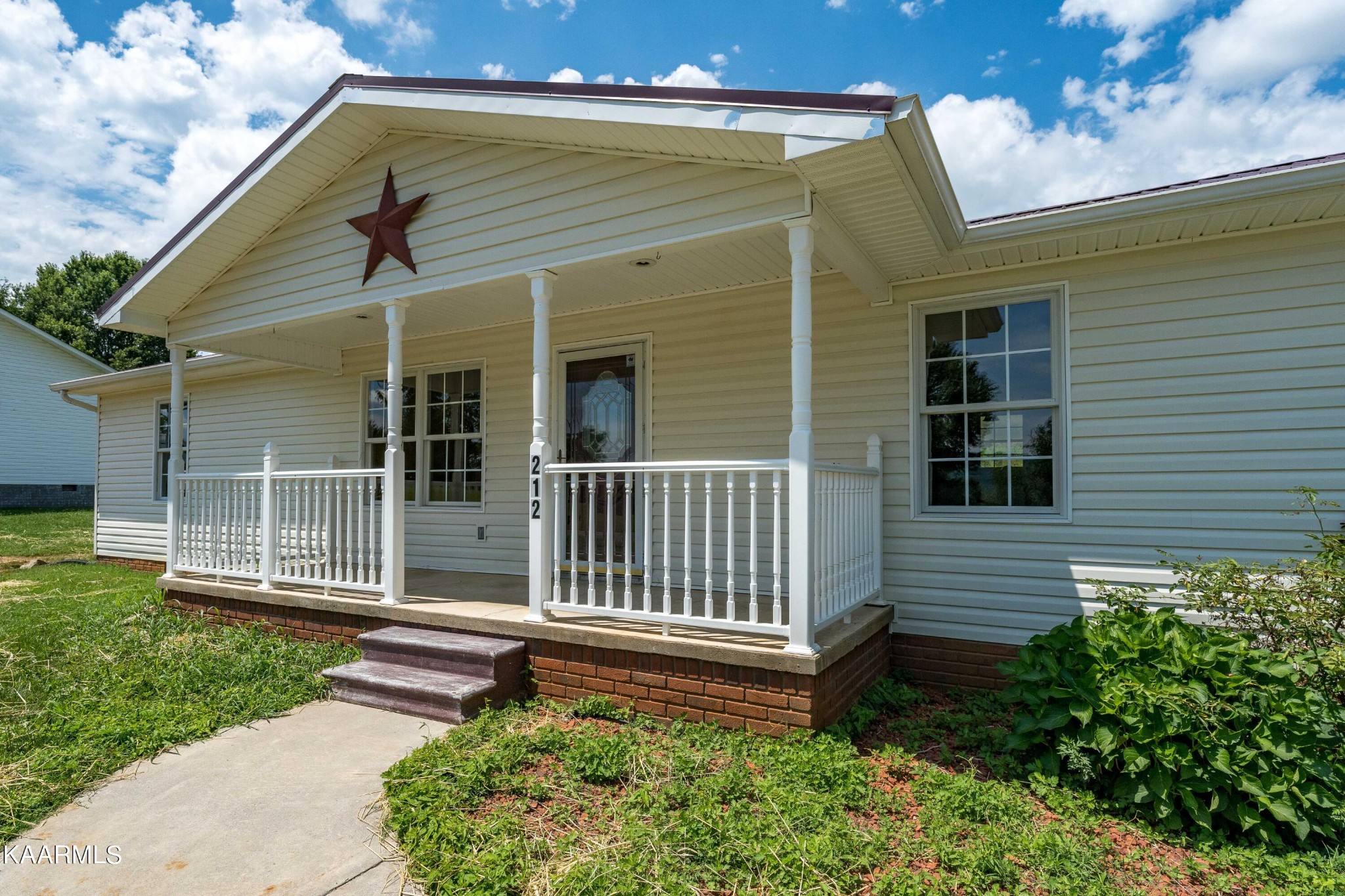 212 George Bowers Road Elizabethton, TN 37643 - Photo 6 of 49 a view of a house with a small yard and wooden fence