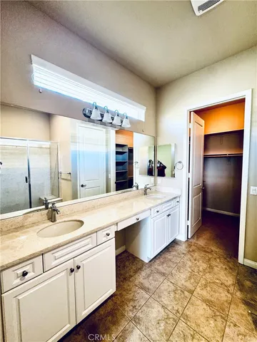 a large bathroom with a sink and a large mirror