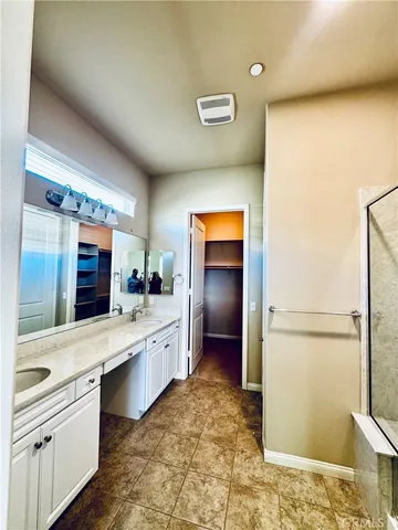 a large bathroom with a granite countertop sink and a mirror