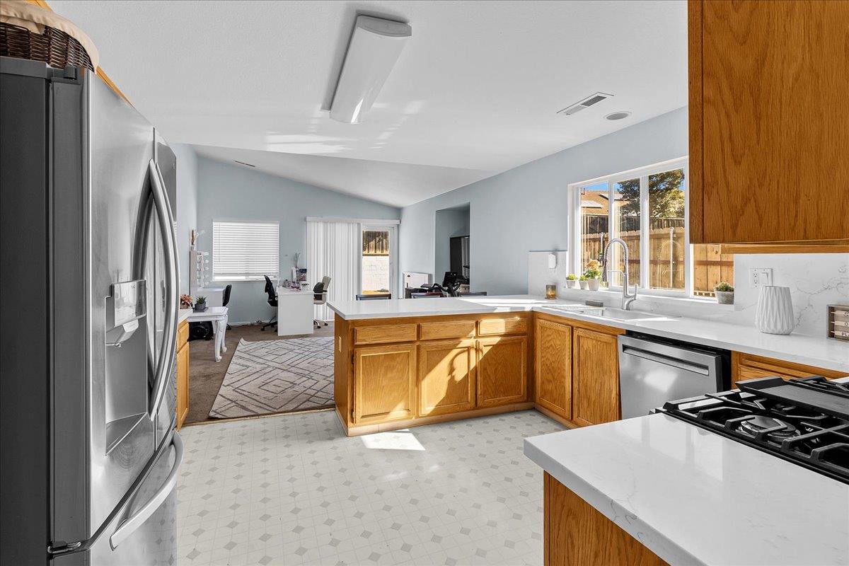 715 Skinner Street Soledad, CA 93960 - Photo 11 of 35 a kitchen with stainless steel appliances granite countertop a sink stove and refrigerator