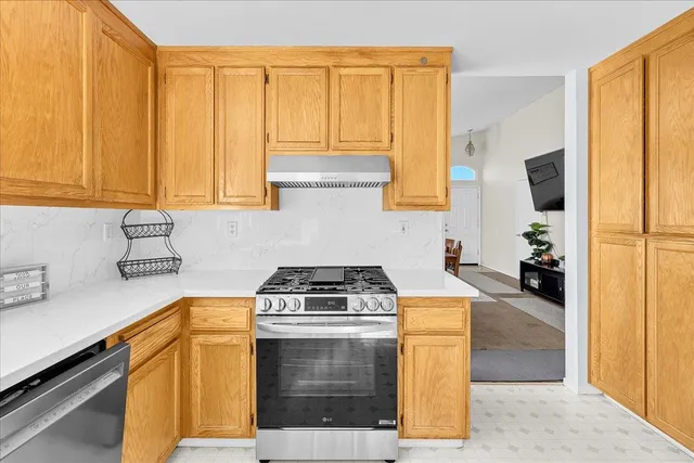 a kitchen with a sink a stove and cabinets