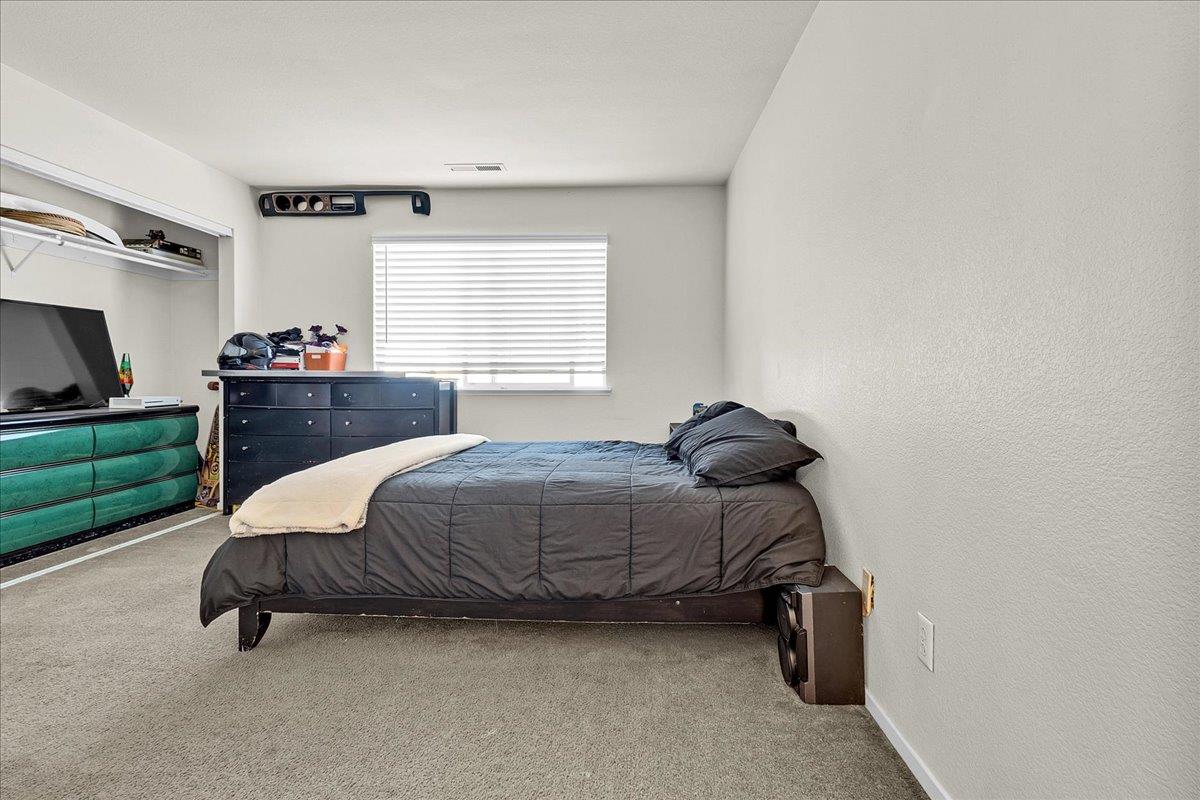 715 Skinner Street Soledad, CA 93960 - Photo 18 of 35 a bedroom with a bed and a dresser in it