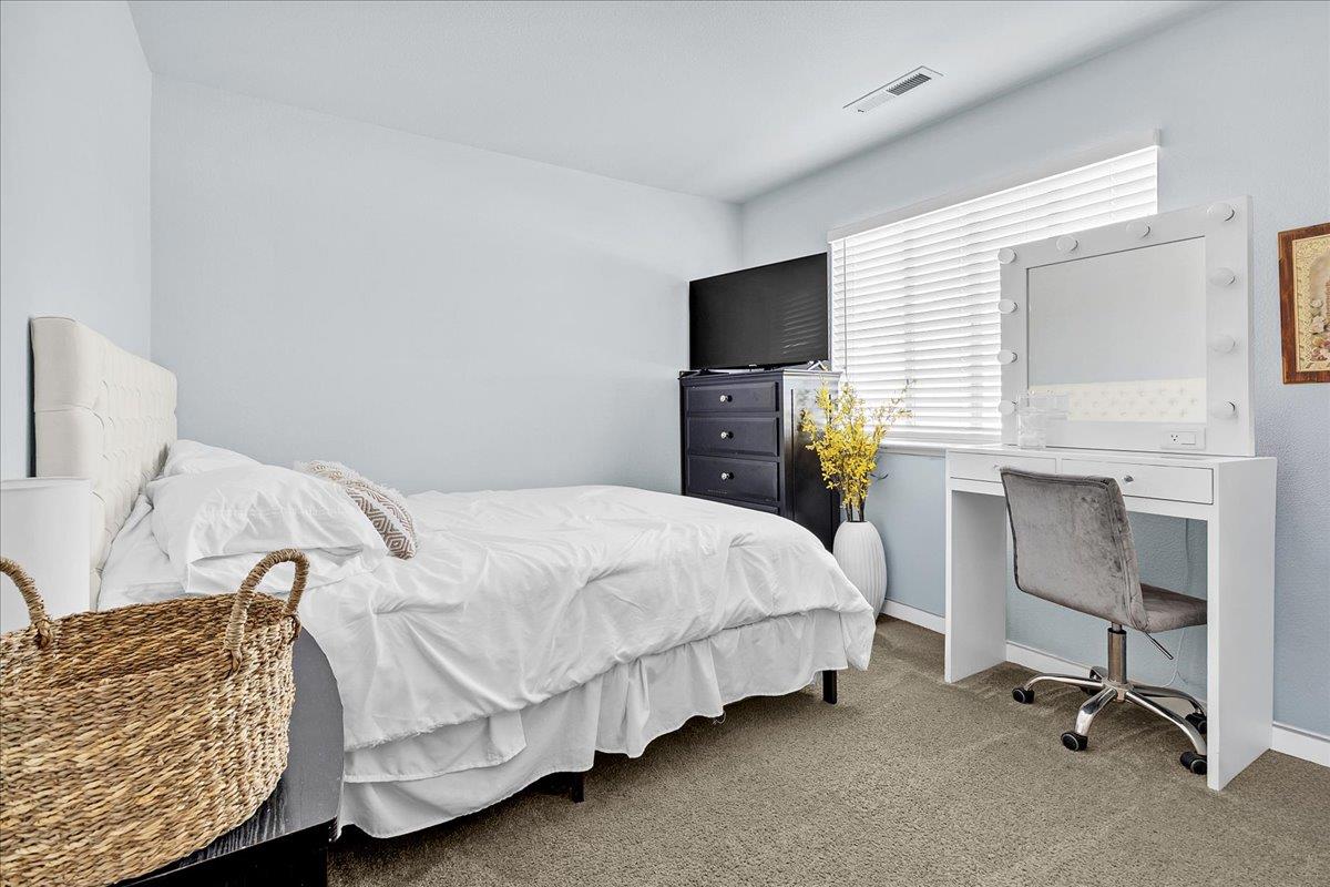 715 Skinner Street Soledad, CA 93960 - Photo 23 of 35 a bedroom with a bed and a flat screen tv