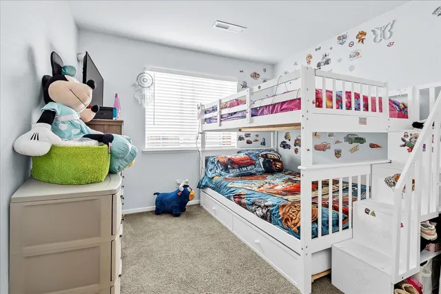 a bedroom with baby crib and hanging chair