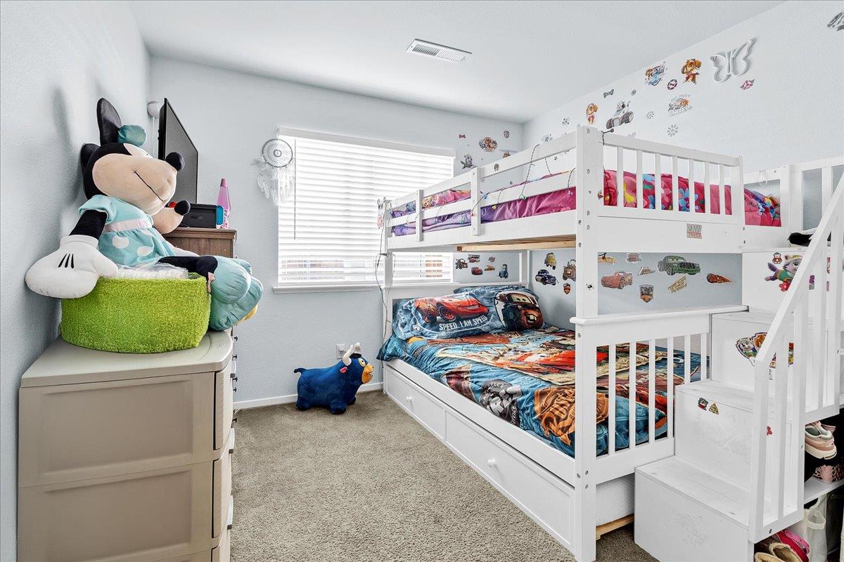 715 Skinner Street Soledad, CA 93960 - Photo 25 of 35 a bedroom with baby crib and hanging chair