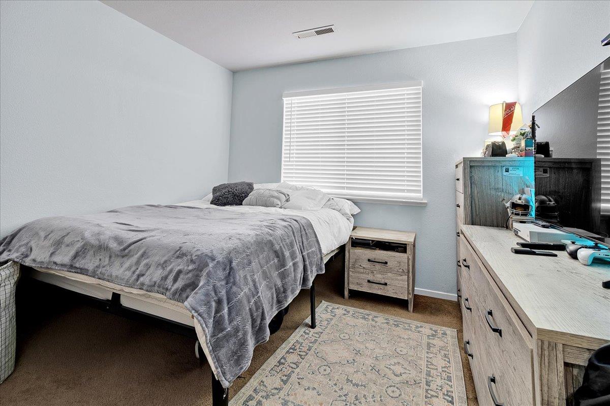 715 Skinner Street Soledad, CA 93960 - Photo 29 of 35 a bedroom with a bed and a tv