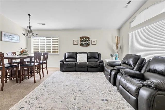 a living room with furniture windows and a dining table
