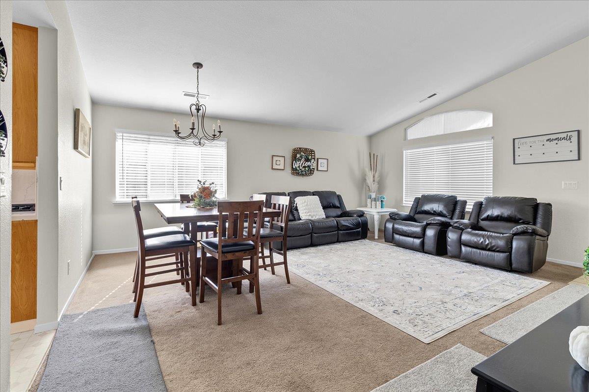 715 Skinner Street Soledad, CA 93960 - Photo 8 of 35 a living room with furniture a chandelier and a dining table