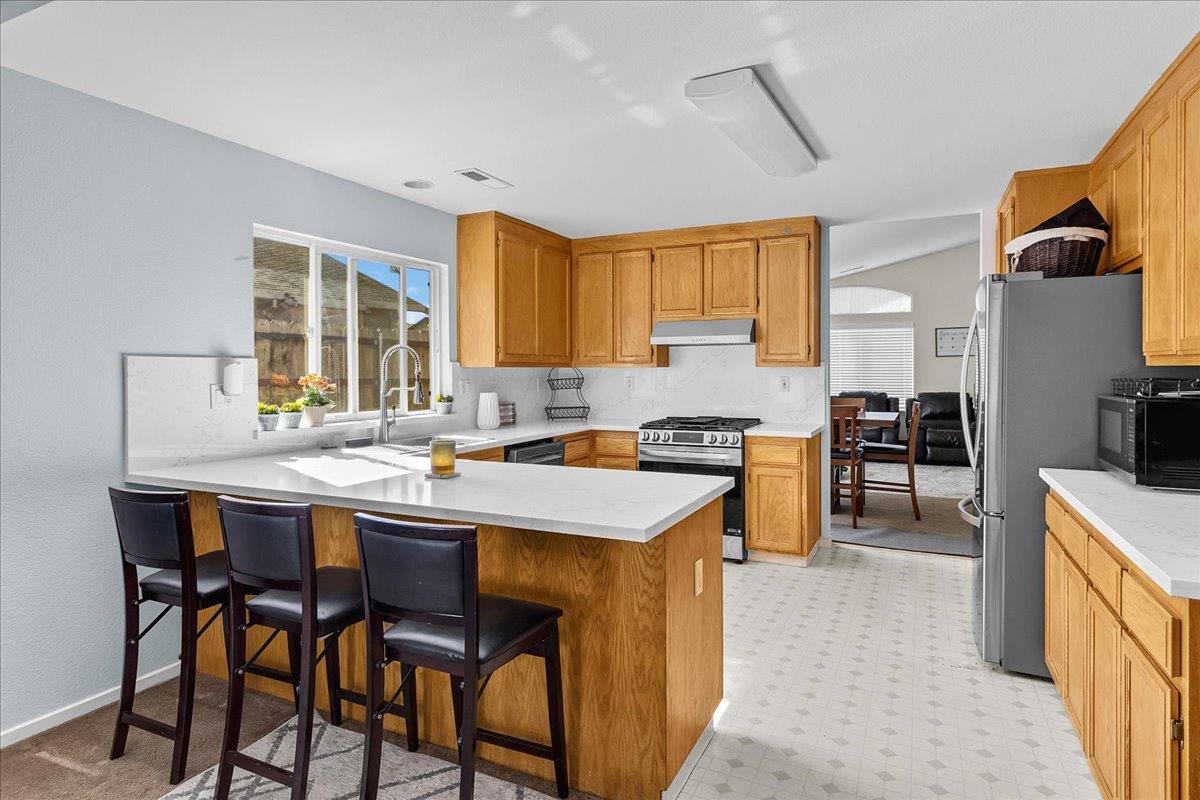 715 Skinner Street Soledad, CA 93960 - Photo 10 of 35 a kitchen with a table chairs sink and cabinets
