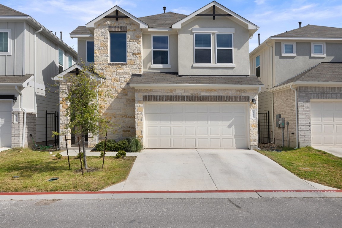a front view of a house with a yard garage and outdoor seating