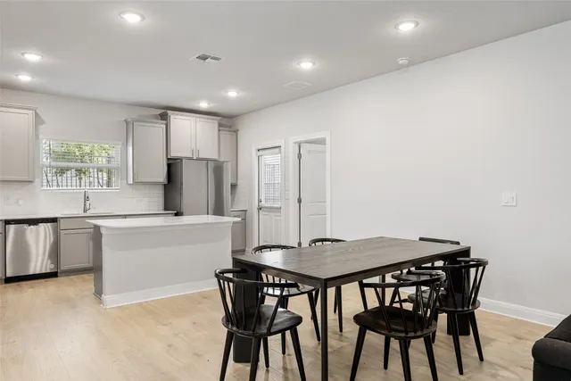 a kitchen with a table and chairs in it