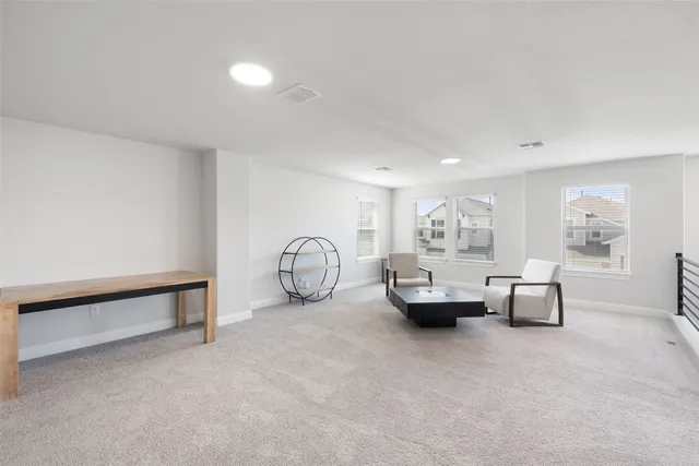 a living room with furniture and white walls