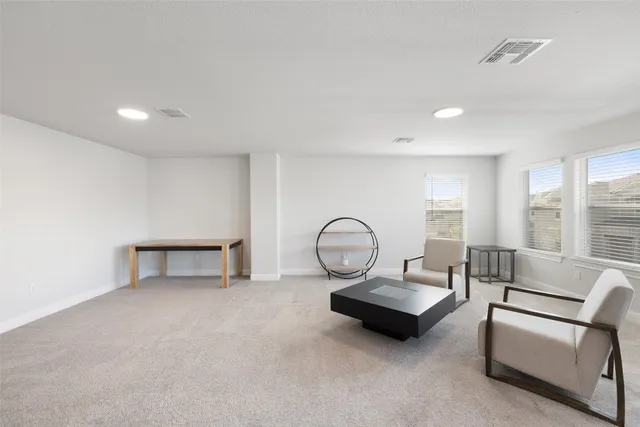 a living room with furniture and a floor to ceiling window