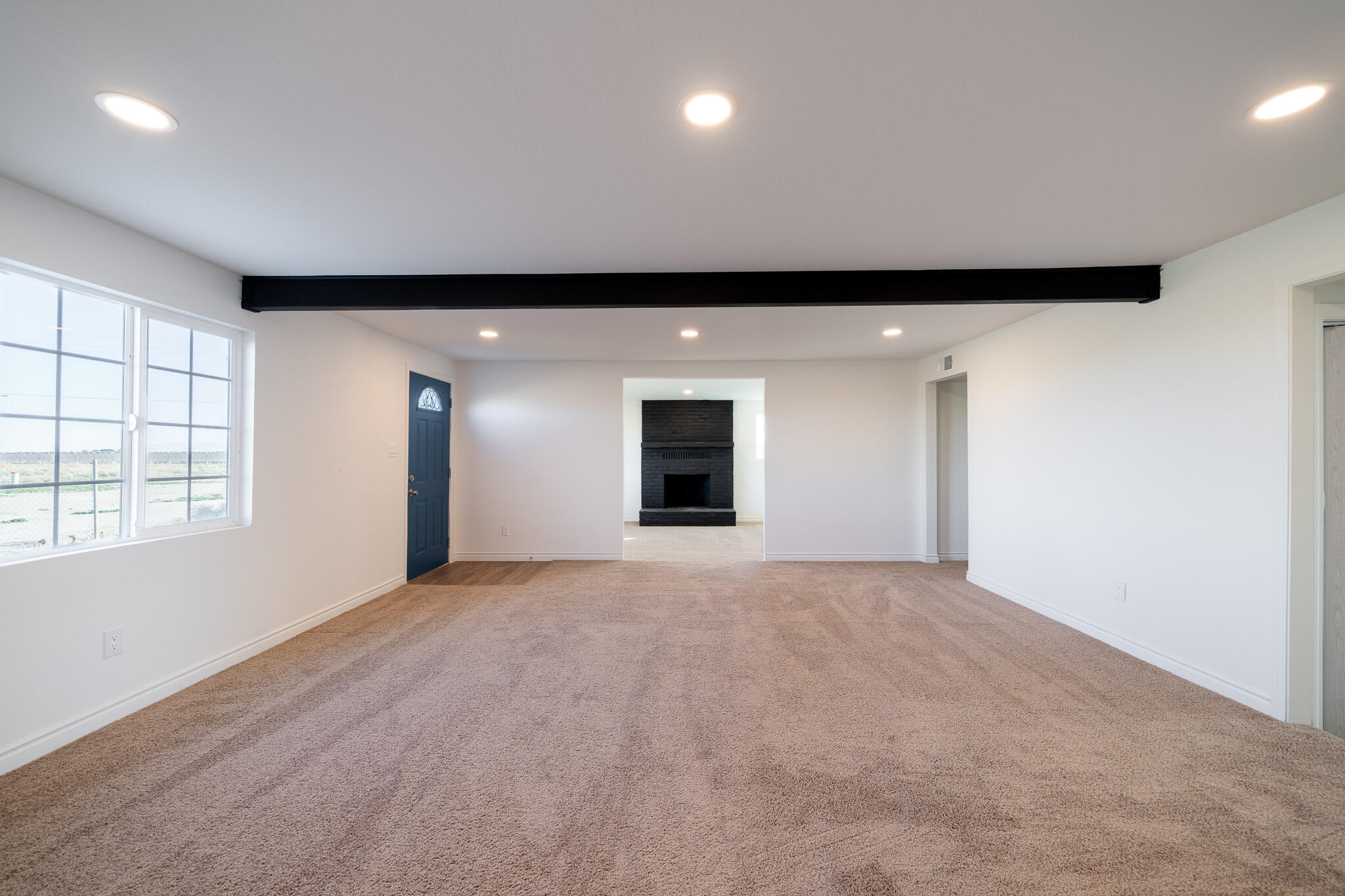 8443 Gaskell Road Rosamond, CA 93560 - Photo 13 of 45 an empty room with windows and cabinet