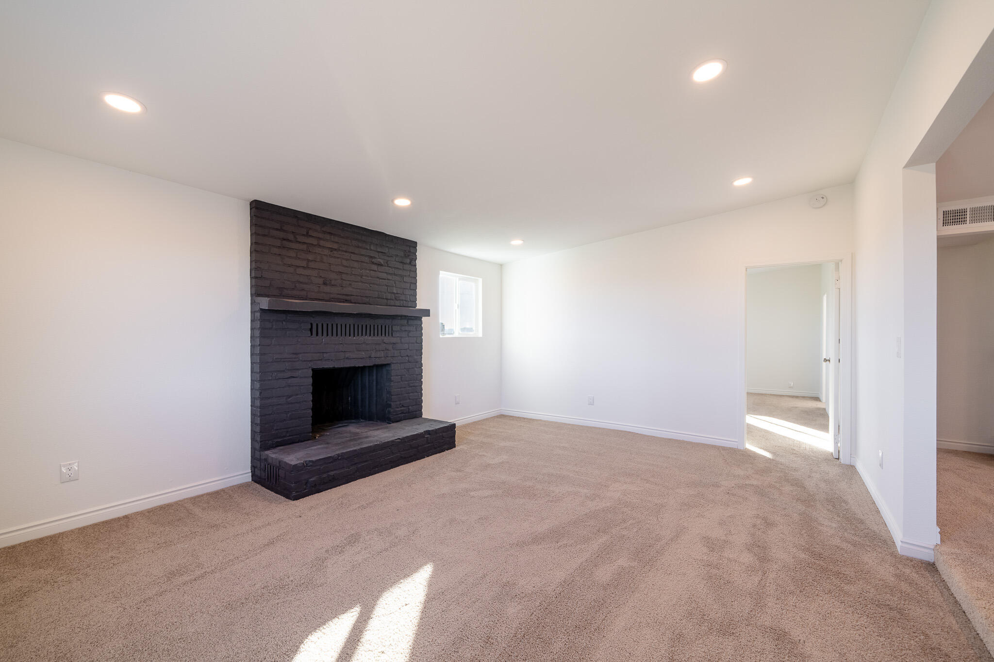 8443 Gaskell Road Rosamond, CA 93560 - Photo 14 of 45 a view of an empty room with a fireplace