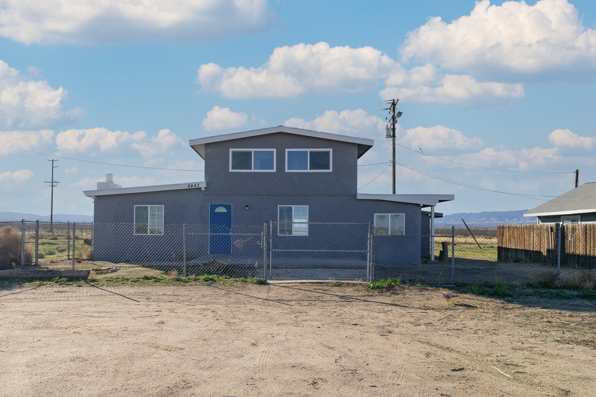 8443 Gaskell Road Rosamond, CA 93560 - Photo 2 of 45 a front view of a house with a yard