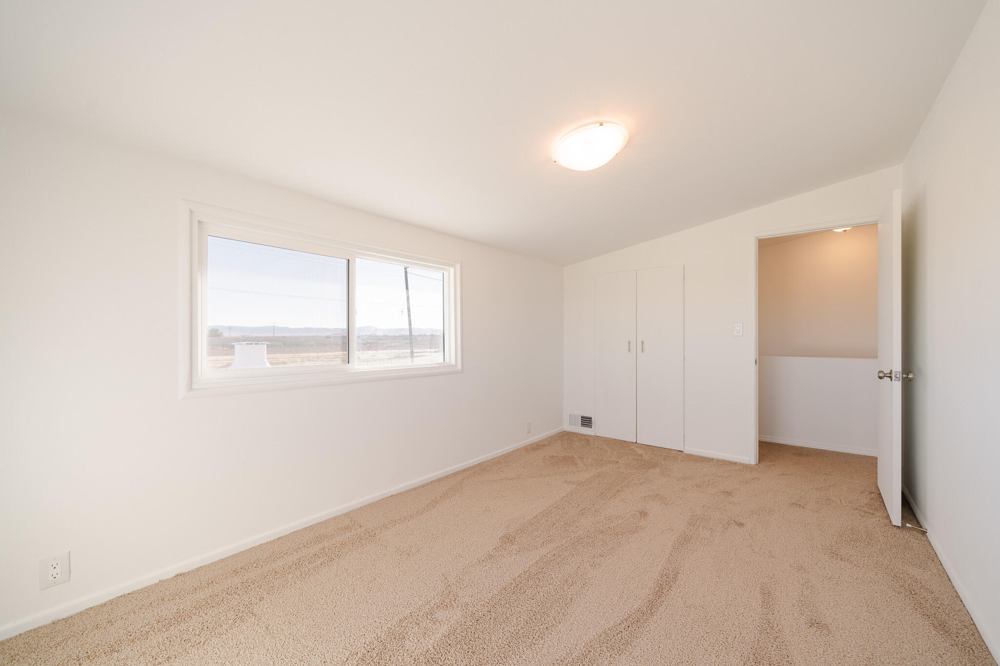 8443 Gaskell Road Rosamond, CA 93560 - Photo 23 of 45 an empty room with windows