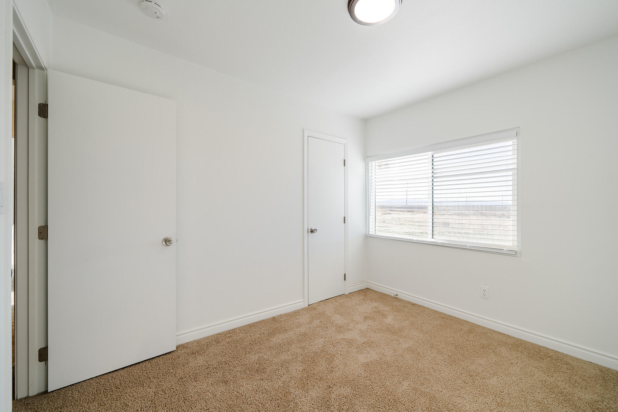 8443 Gaskell Road Rosamond, CA 93560 - Photo 25 of 45 a view of an empty room with a window