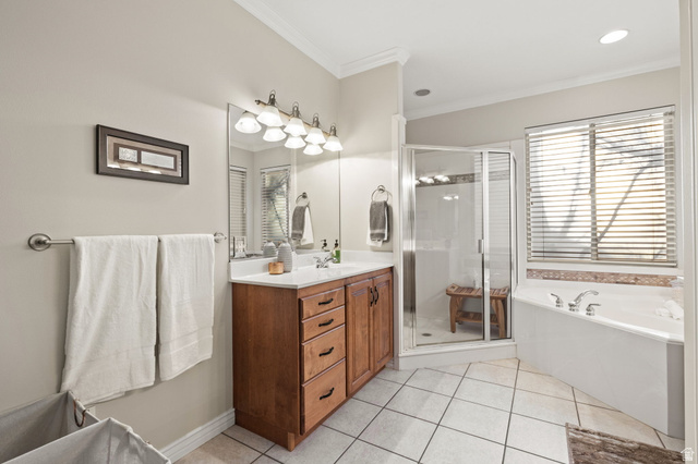 6208 West Bull River Road Highland, UT 84003 - Photo 37 of 90 Bathroom featuring a wood-finish vanity with a single sink, large mirror, and overhead lighting