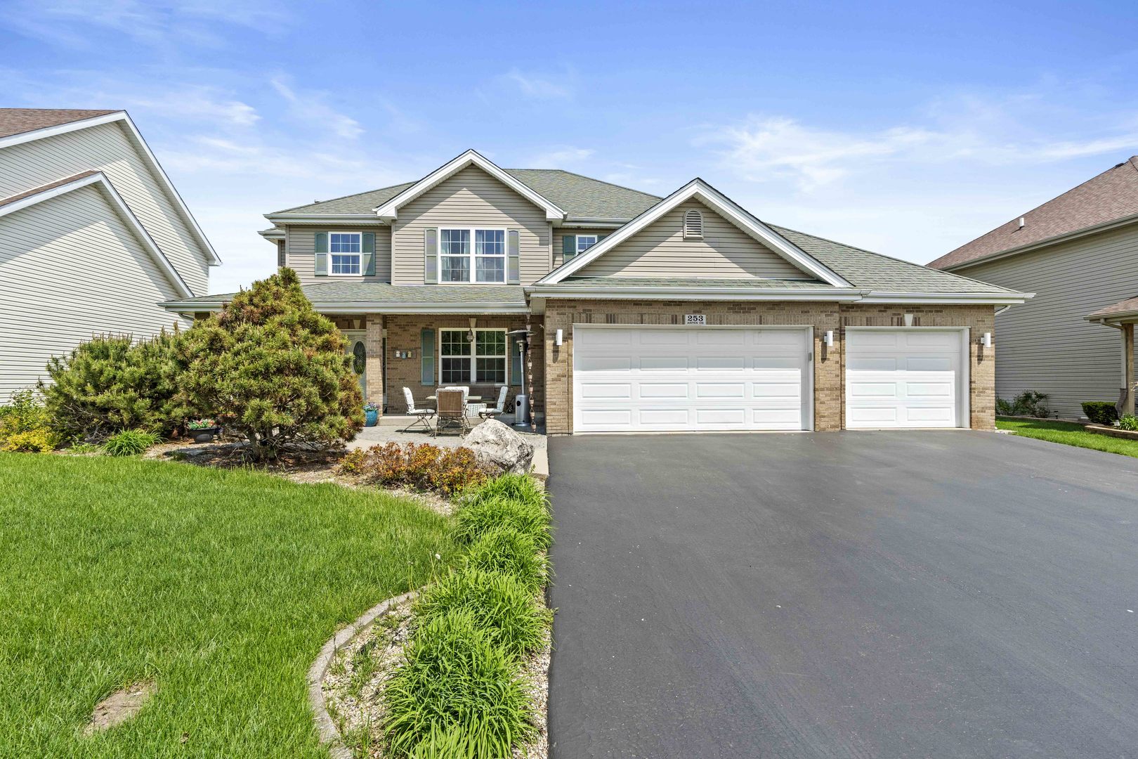 253 Aspen Drive Beecher, IL 60401 - Photo 1 of 17 a front view of a house with a yard and garage