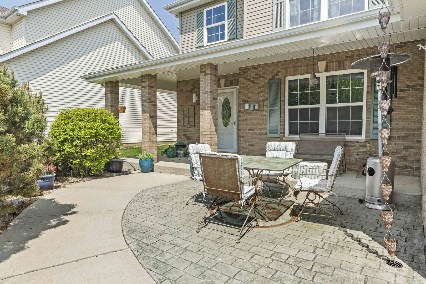 253 Aspen Drive Beecher, IL 60401 - Photo 11 of 17 a view of a patio with table and chairs and potted plants