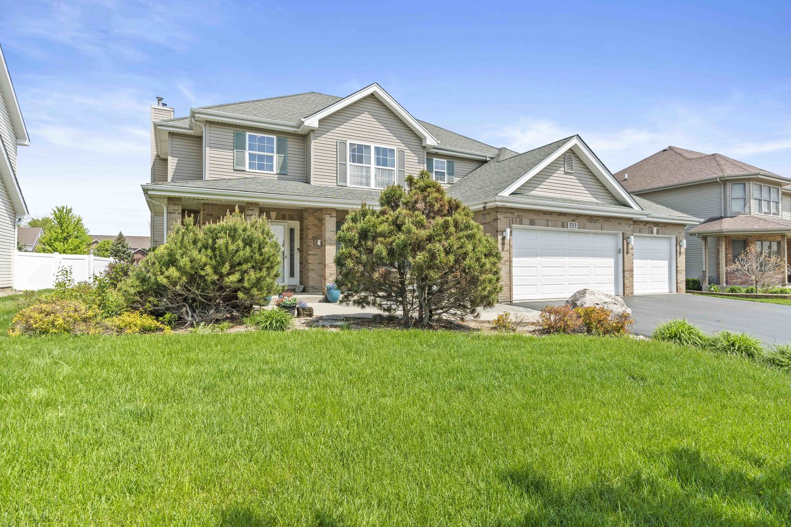 253 Aspen Drive Beecher, IL 60401 - Photo 12 of 17 a front view of a house with a garden