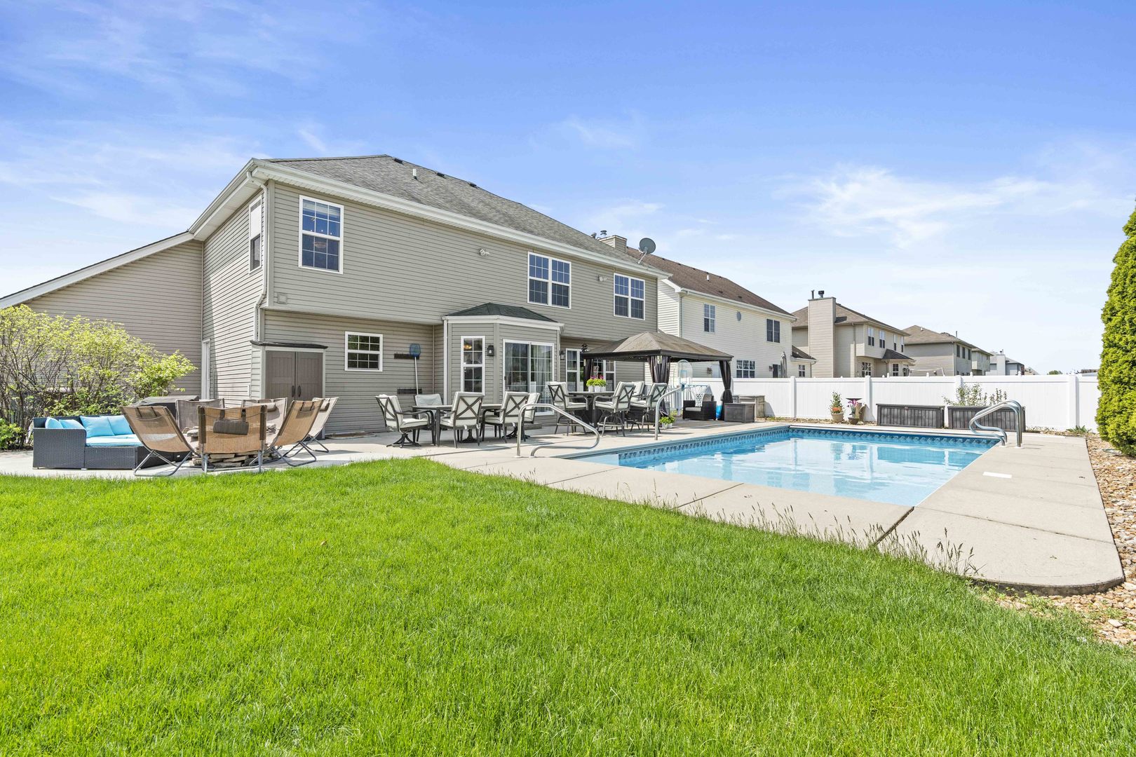 253 Aspen Drive Beecher, IL 60401 - Photo 2 of 17 a front view of a house with swimming pool yard and patio