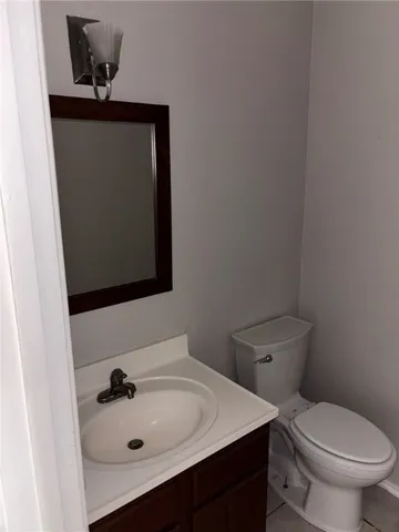 a bathroom with a sink toilet and mirror