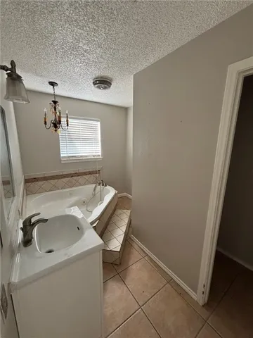 a bathroom with a sink and a washer dryer