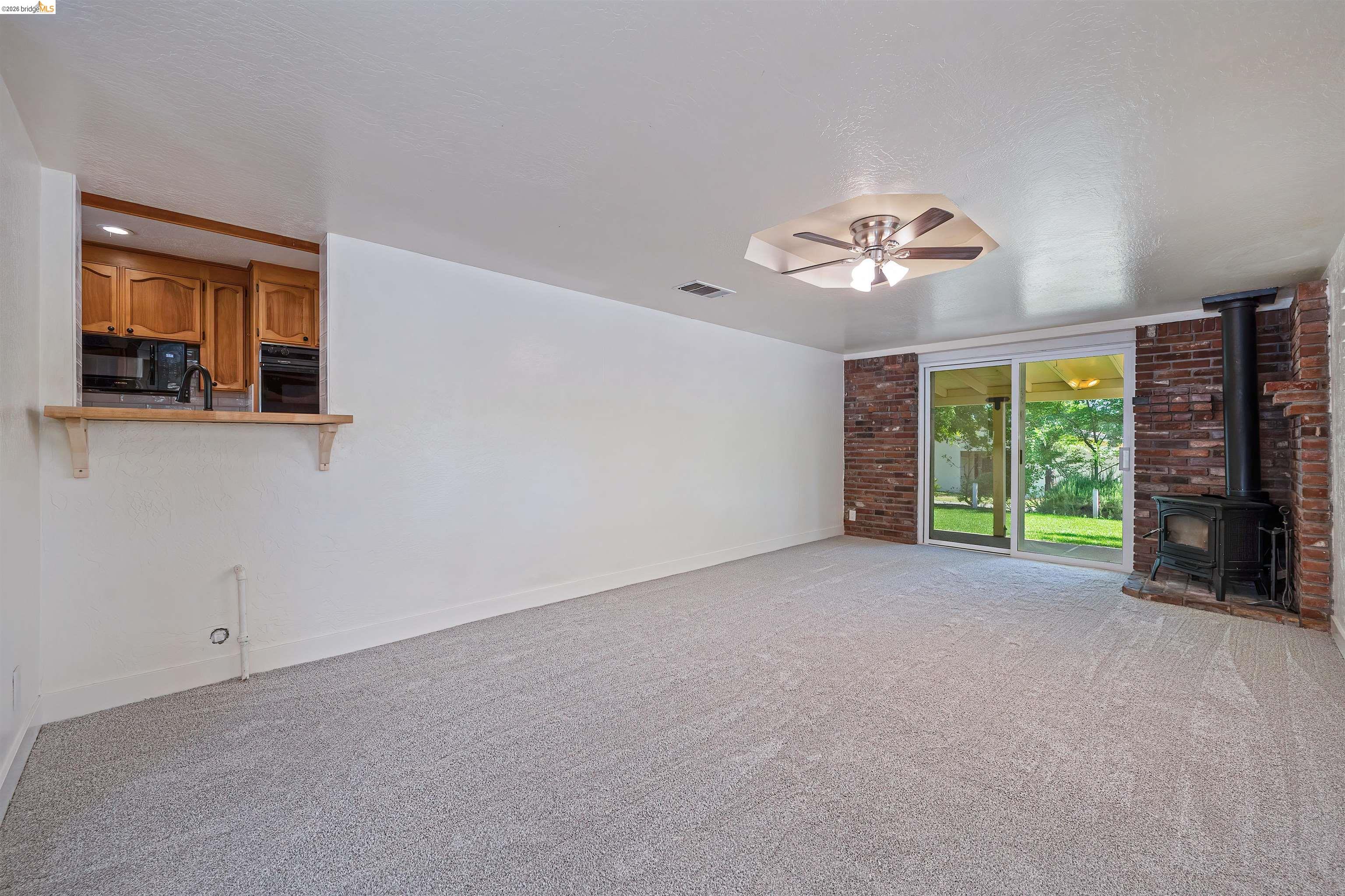10474 Sheldon Road Elk Grove, CA 95624 - Photo 9 of 83 Spacious room with light-toned carpeting and white walls